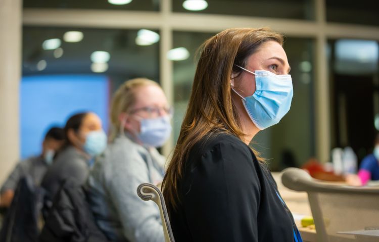Drs. Marina Sharifi, Dana Ley, and Sara Donohue watching someone out-of-frame speak